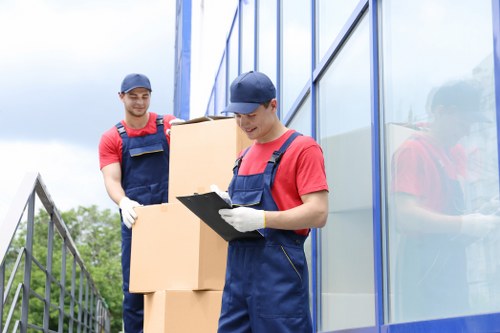 Movers planning a safe relocation with protective equipment and packing materials