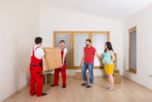 Professional movers loading household items near Holland Park properties