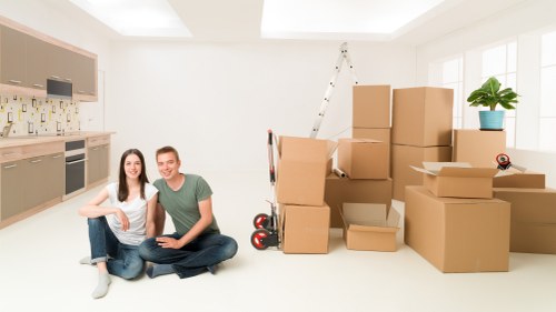 Assorted moving boxes, tape, and protective wrapping for packing in Holland Park