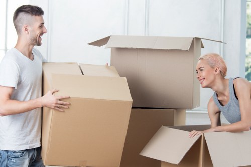 Worker using safe manual handling techniques with equipment