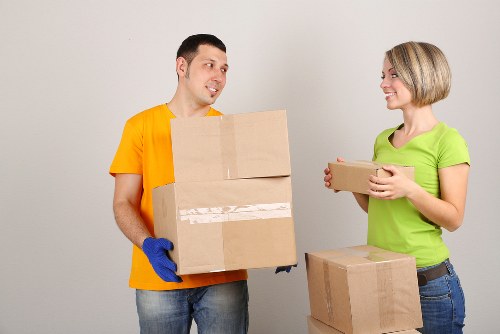 Professional movers navigating a London townhouse staircase